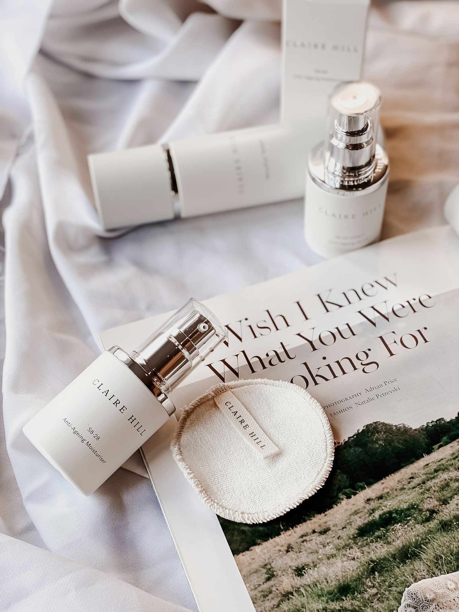 Beauty and fragrance still life on an open magazine